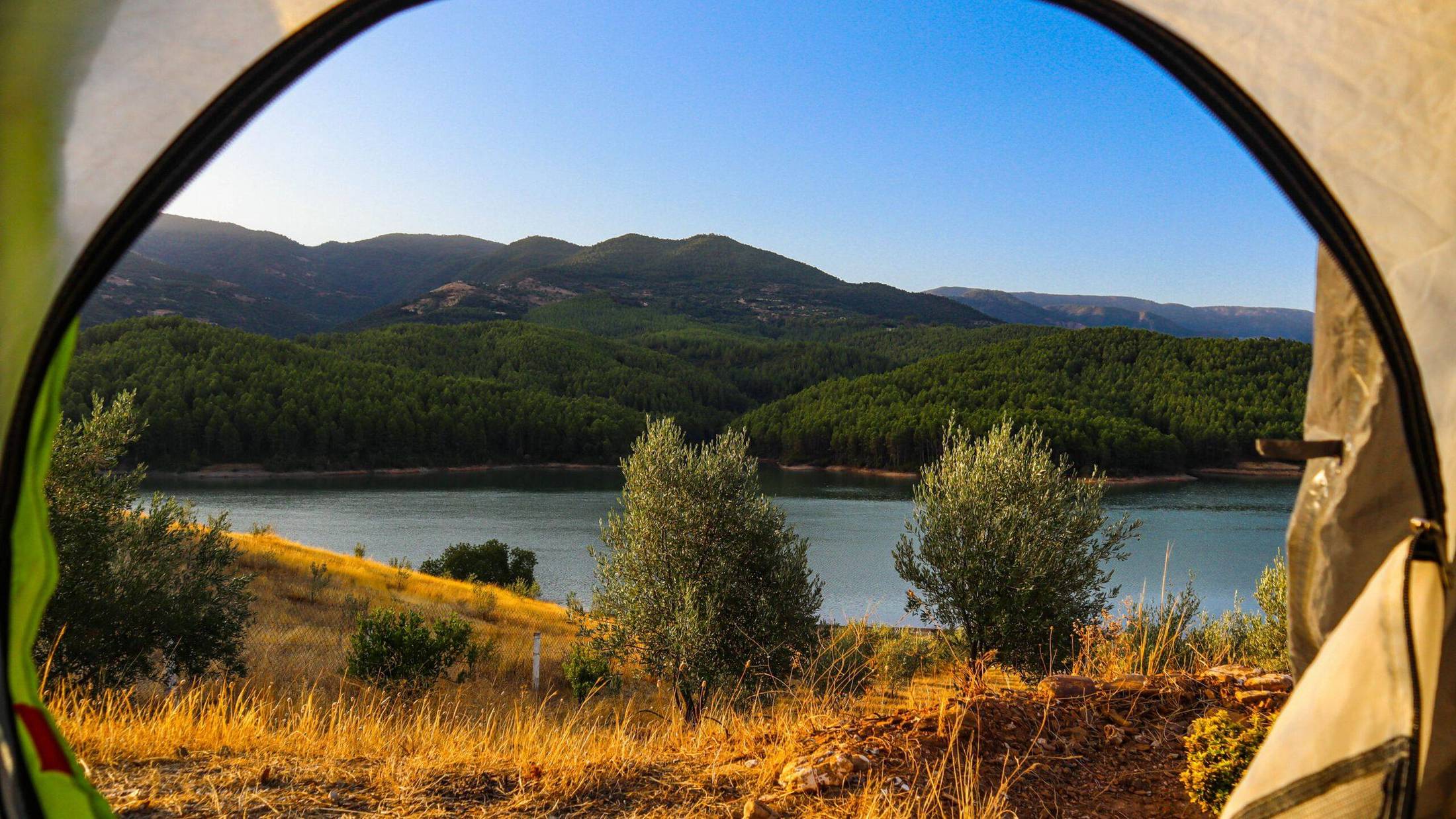 View from a tent over a lake and hills in Morocco